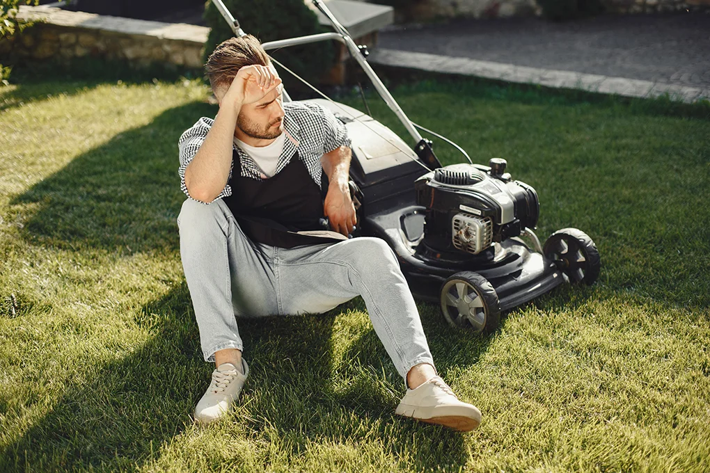 man-cutting-grass-with-lawn-mover-back-yard-male-black-apron